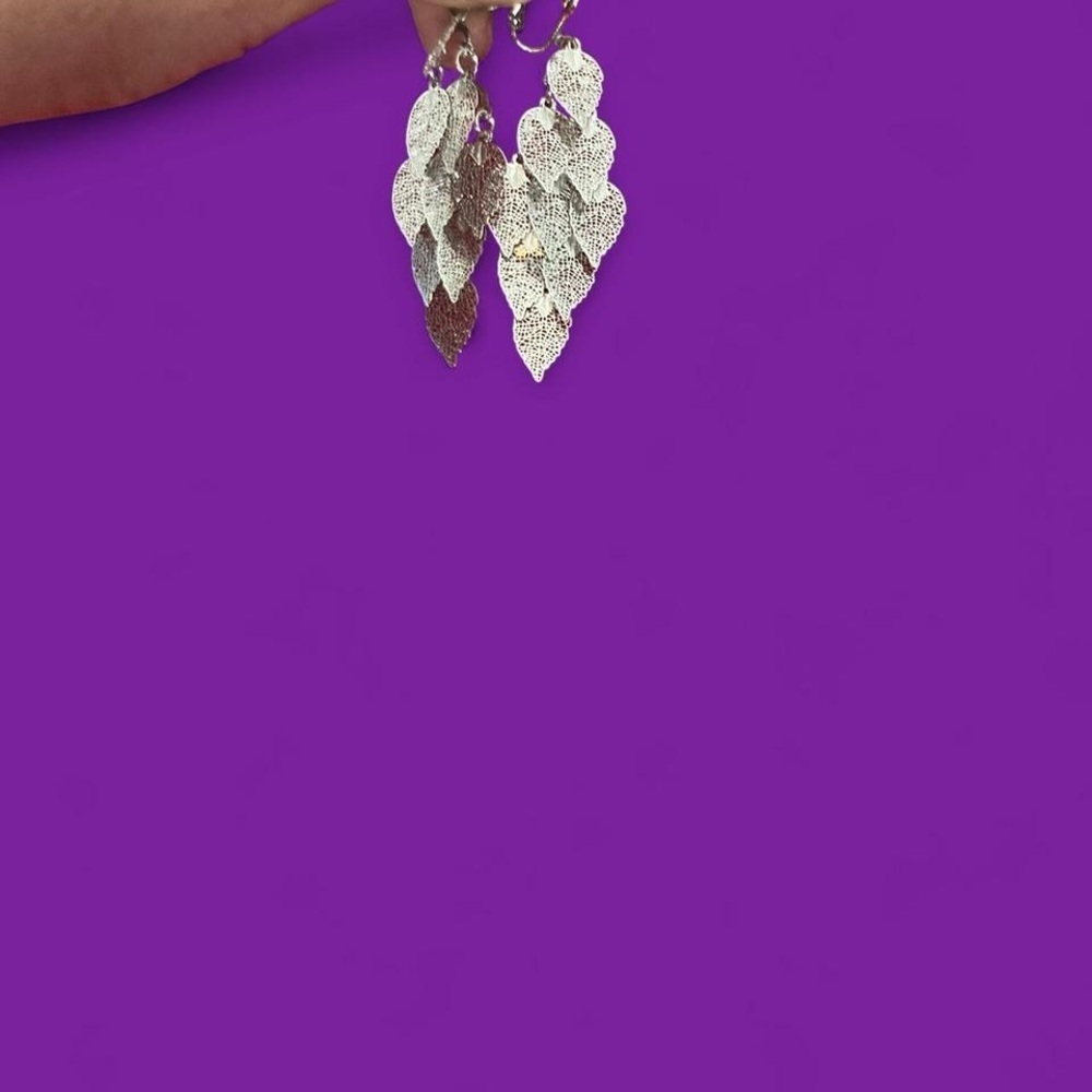 Silver tone dangling leaf earrings with a touch of glamour